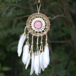 Pastel pink macramé dream catcher with feathers, handmade in Bali.