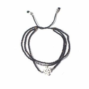 Handcrafted Temple String Bracelet featuring a sacred silver symbol.