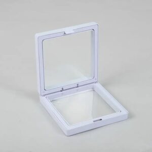 White 3D floating frame display showcasing jewellery and collectibles.