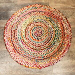 Handmade round jute and recycled cotton rug, soft and durable, perfect for home decor.