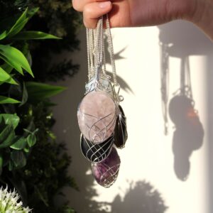 Elegant rose quartz necklace with a delicate swirl design, perfect for any outfit.
