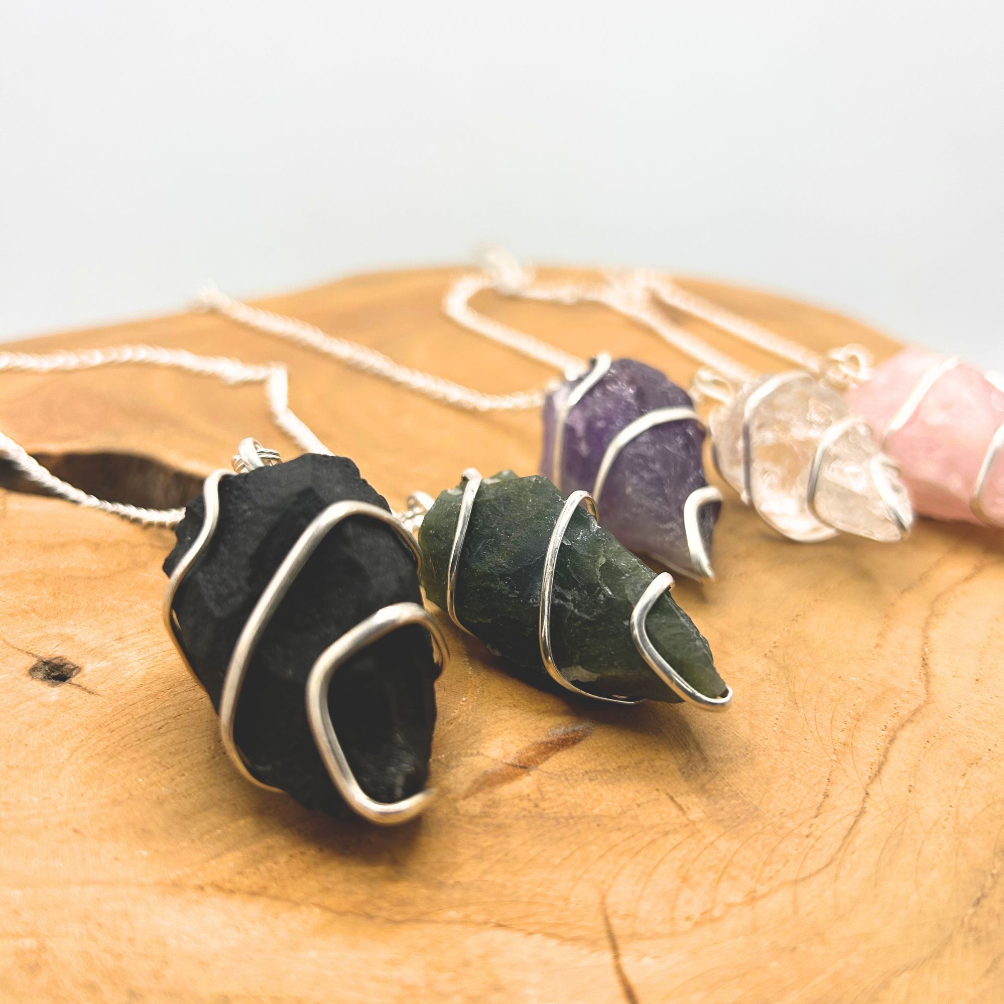 Raw moss agate pendulum with silver-tone spiral and fine chain.