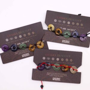 Large donut-shaped gemstones bracelet representing different chakras.