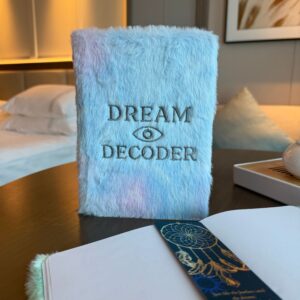 Soft pastel faux-fur dream journal with embroidered all-seeing eye design.