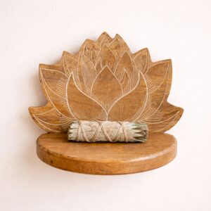 Whitewashed lotus wall shelf with intricate carvings for home decor.