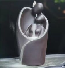 Elegant backflow incense burner shaped like lovers embracing.