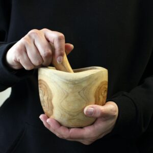 Natural teak pestle and mortar set, perfect for everyday culinary use.