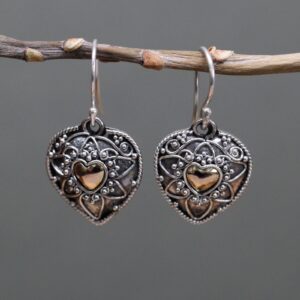 Elegant silver and gold mandala heart earrings with a hook fitting.