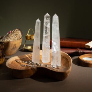 Polished Rock Crystal Six Face Obelisk Point showcasing clear tones and elegant design.