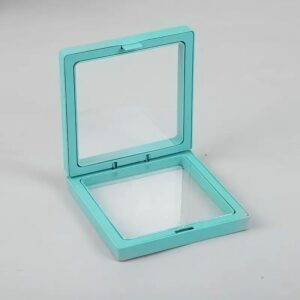 Teal 3D floating frame display showcasing jewellery and decorative items.