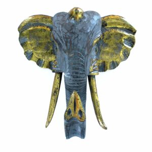 Large elephant head sculpture in gold and grey, showcasing intricate carvings.