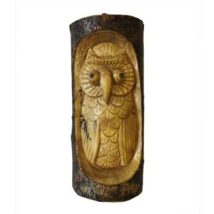 Unique owl carving in a tree trunk, perfect for garden or home decor.
