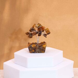 Mini gemstone tree made of Tiger Eye stones on an orgonite base.
