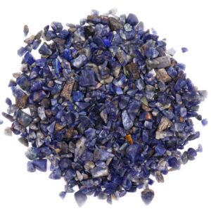 Natural sodalite gemstone chips in a bulk bag, showcasing deep blue hues.