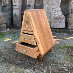 Handmade triangle storage chest with three drawers in rustic finish.
