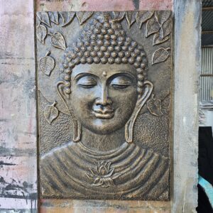 Antique gold relief of a Buddha in an iron frame, perfect for home decor.