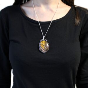 Elegant Tiger Eye gemstone necklace with a silver swirl design.