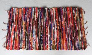 Handmade small velvet rug in vibrant colours, perfect for adding comfort to any room.