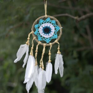 Pastel blue macramé dream catcher with feathers, handmade in Bali.