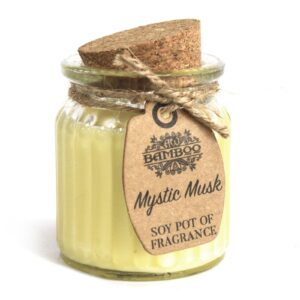 Reusable glass jar candle with cork lid and natural label, emitting a warm glow.
