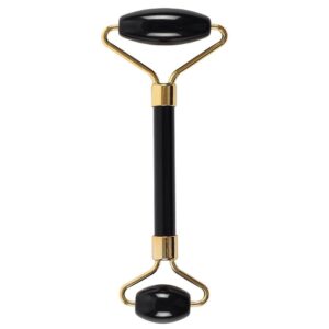 Black obsidian face roller with a gold-toned frame for skincare rituals.