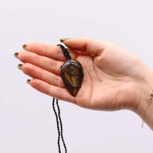 Handcrafted Tigereye teardrop pendant with adjustable string, showcasing its natural beauty.