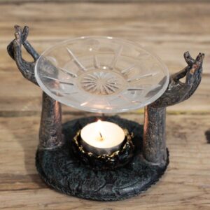 Antique Buddha oil burner with Om hands design for a serene atmosphere.