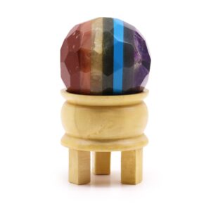 Faceted gemstone ball with wooden stand, representing the seven chakras.