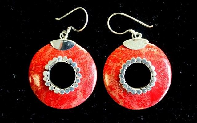 Hand-made 925 silver earrings with a smooth, shiny coral design.