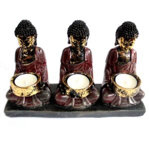 Antique Buddha candle holder with three devotees, perfect for meditation spaces.