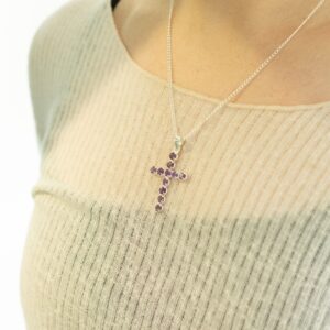 Silver plated Indian crucifix pendant with amethyst-coloured stones on a chain.
