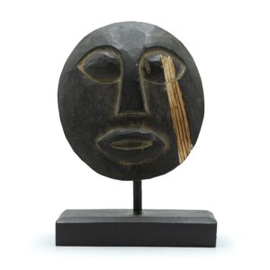 Handcrafted black Timor tribal decorative mask with intricate carvings.