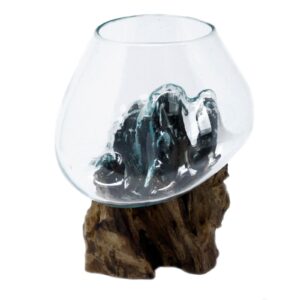 Handmade molten glass bowl resting on a piece of Balinese wood.