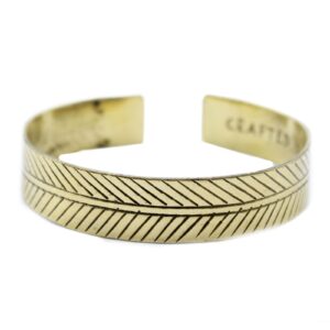Wide tribal leaf design on a brass Tibetan bracelet for mindful living.