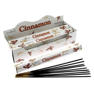 Cinnamon Premium Incense sticks in a stylish holder, creating a calming atmosphere.