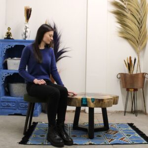Aqua resin-filled tamarind wood coffee table with metal legs.