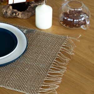 Natural seagrass placemat with fringe detailing, perfect for dining decor.