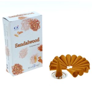 Sandalwood incense cones with a metal holder for a calming atmosphere.