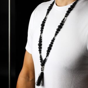 Handmade necklace featuring natural lava stone and a silver Buddha charm.