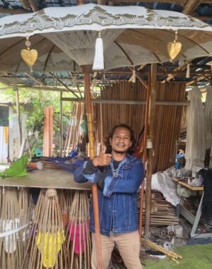 Handcrafted Bali Patio Parasol with subtle gold patterns for outdoor decor.