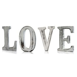 Handmade white wooden letters spelling 'LOVE' for home decor.