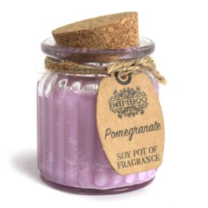 Pomegranate soy candle in a reusable glass jar with cork lid and jute twine.