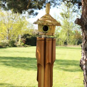 Large round seagrass bird box with chimes, perfect for home decor.