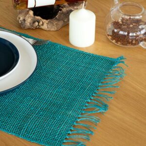 Handcrafted turquoise seagrass placemat with fringe detailing for dining.