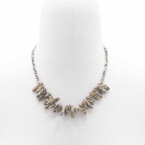 Dalmatian Stone necklace featuring unique black spots on a creamy background.