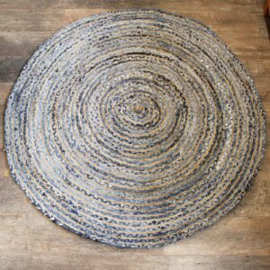 Handmade round jute and recycled denim rug, soft and durable for home decor.