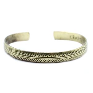 Slim brass Tibetan bracelet featuring a tribal leaf design.