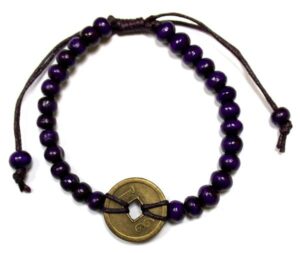 Purple Good Luck Feng Shui Bracelet featuring wooden beads and coins.