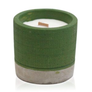 Green concrete pot candle with wooden wick and natural herbs.