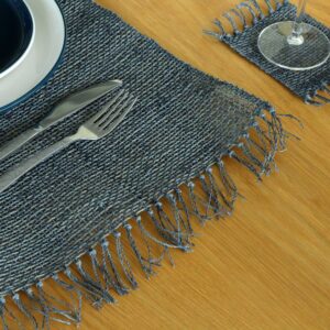 Handwoven seagrass placemat in charcoal with fringe detailing for dining decor.